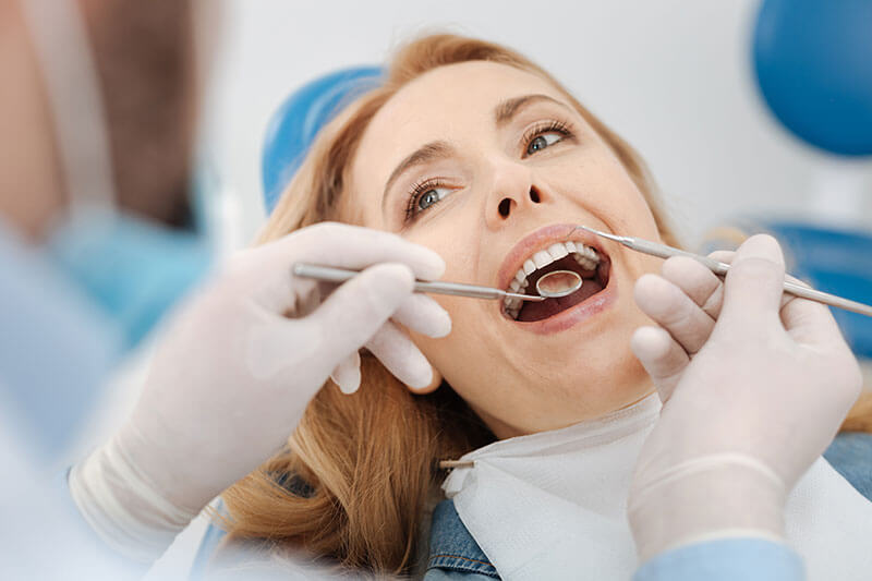 female patient getting a dental exam